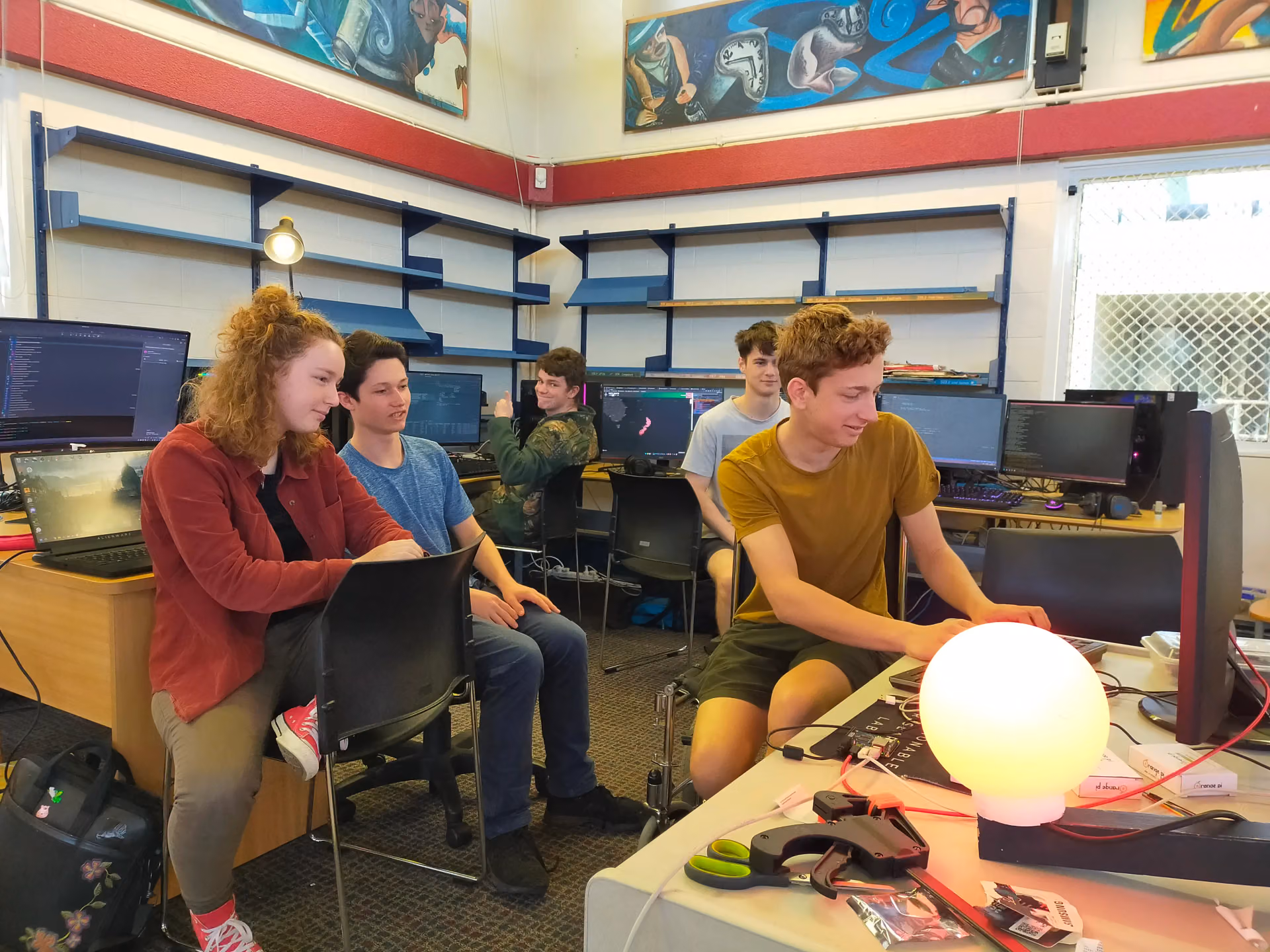 Team sitting around the first prototype globe Team sitting around the first prototype globe